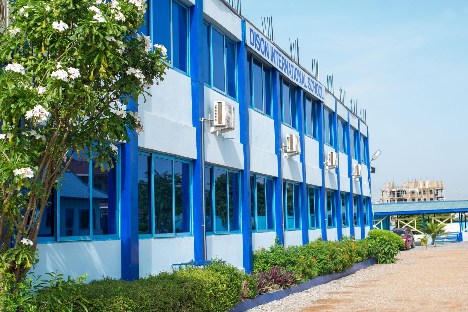 The blue-and-white main building of Dison International School at Burma Hills